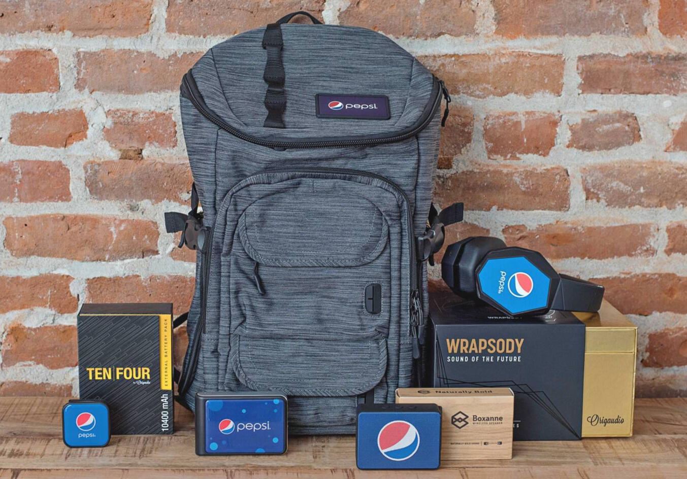 Backpack and speaker branded with a company logo for an onboarding kit